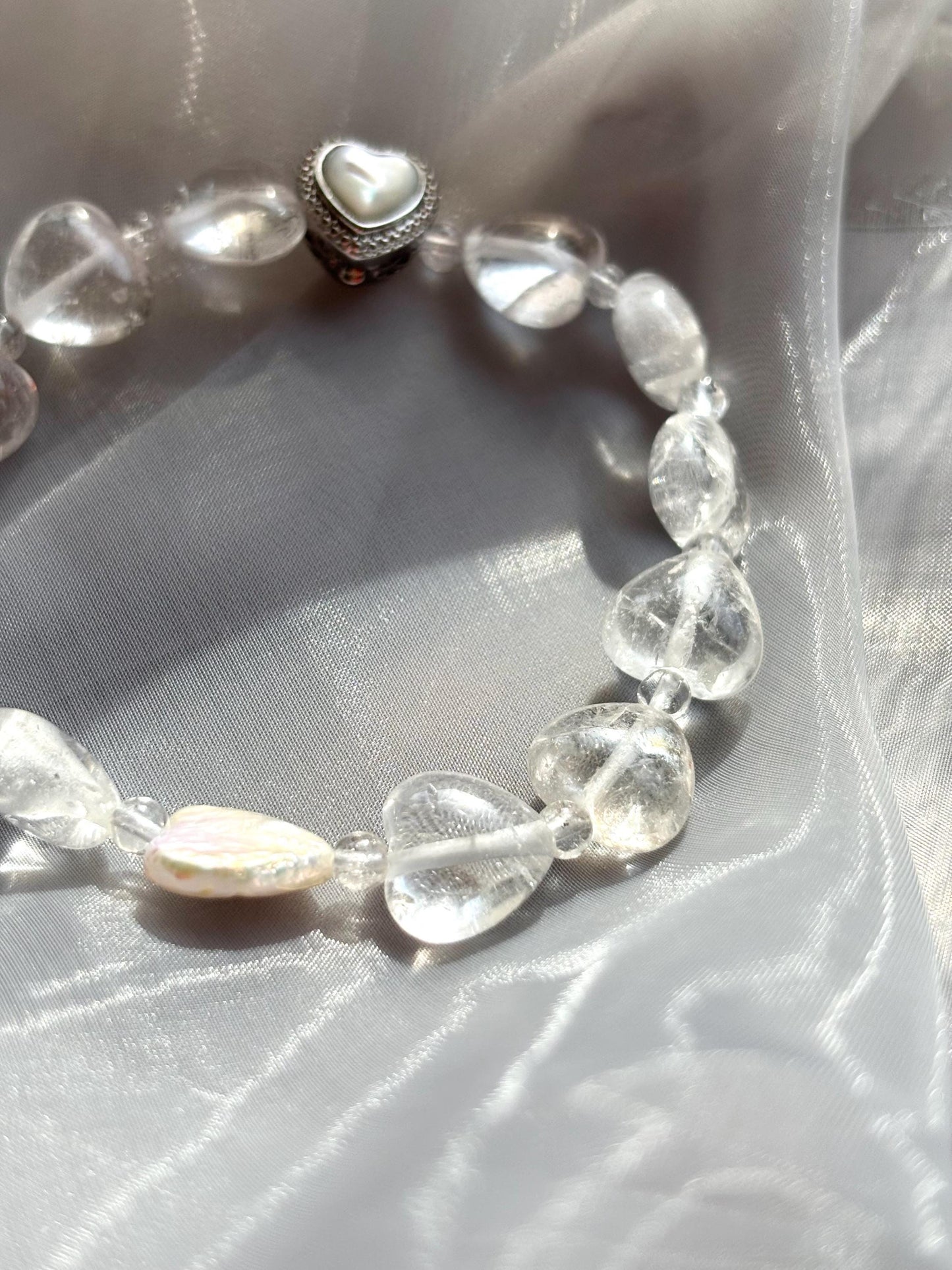 Icy Heart Clear Quartz Bracelet with Heart-Shaped Beads, Pearl, and Mother of Pearl Accents.