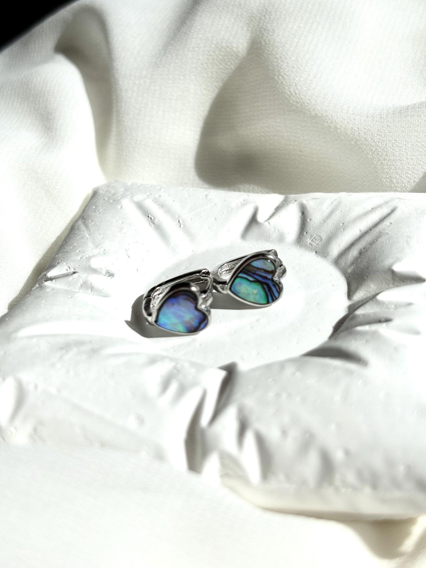 Heart-Shaped Mother of Pearl Huggie Earrings with Black and Blue Hues – Sterling Silver Wire