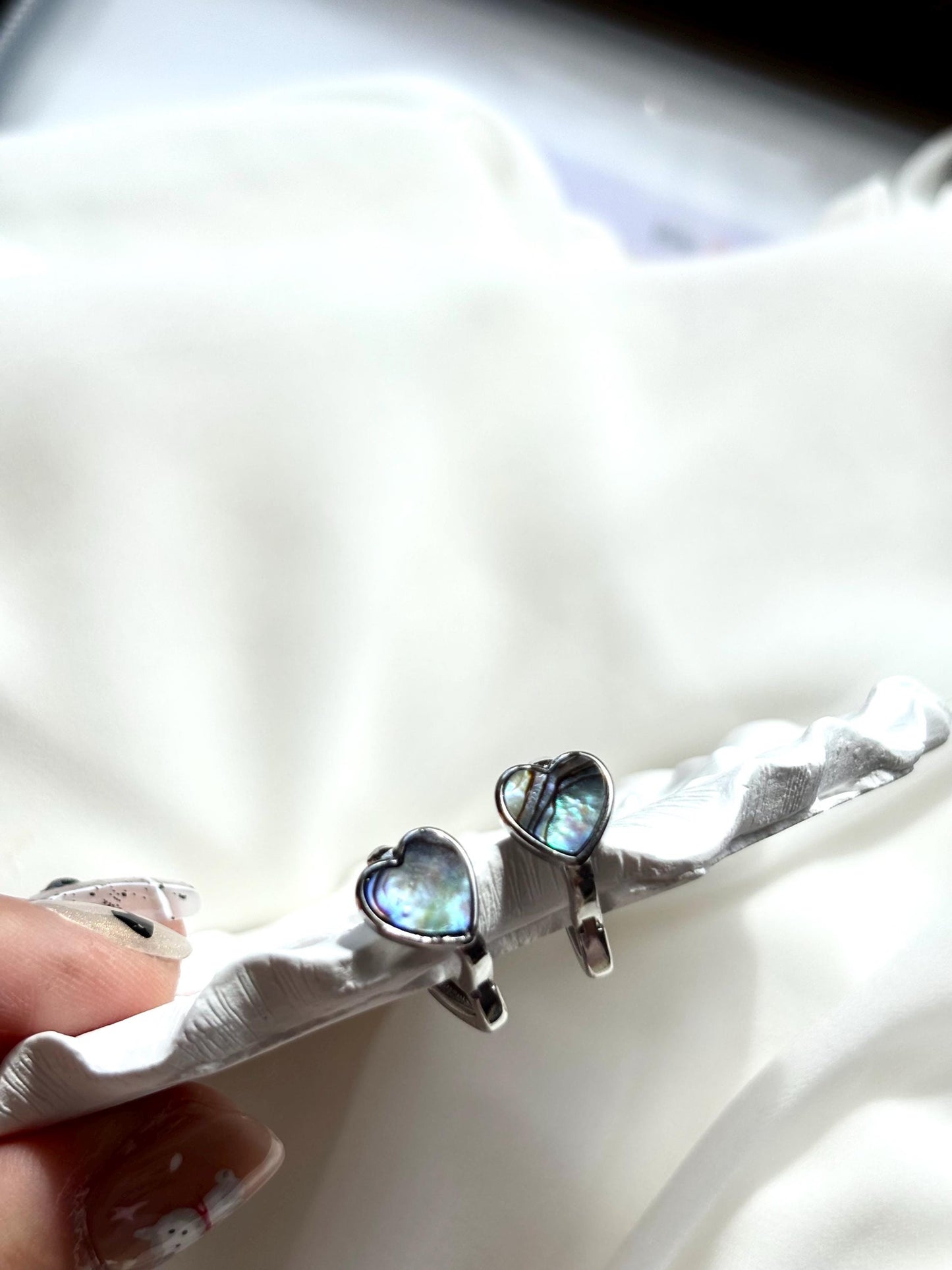 Heart-Shaped Mother of Pearl Huggie Earrings with Black and Blue Hues – Sterling Silver Wire