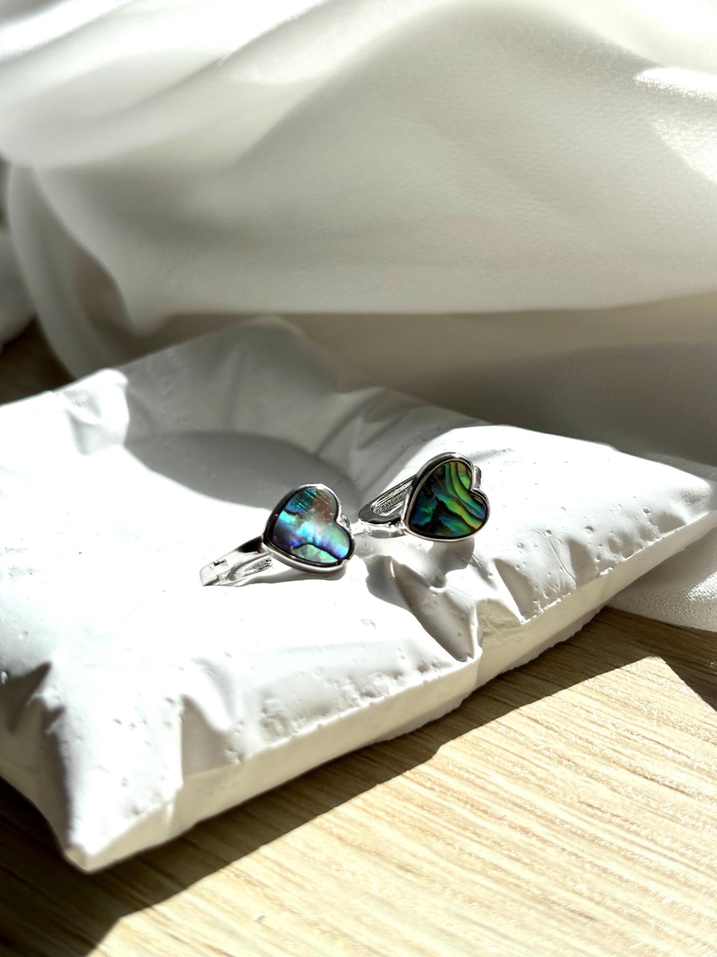 Heart-Shaped Mother of Pearl Huggie Earrings with Black and Blue Hues – Sterling Silver Wire