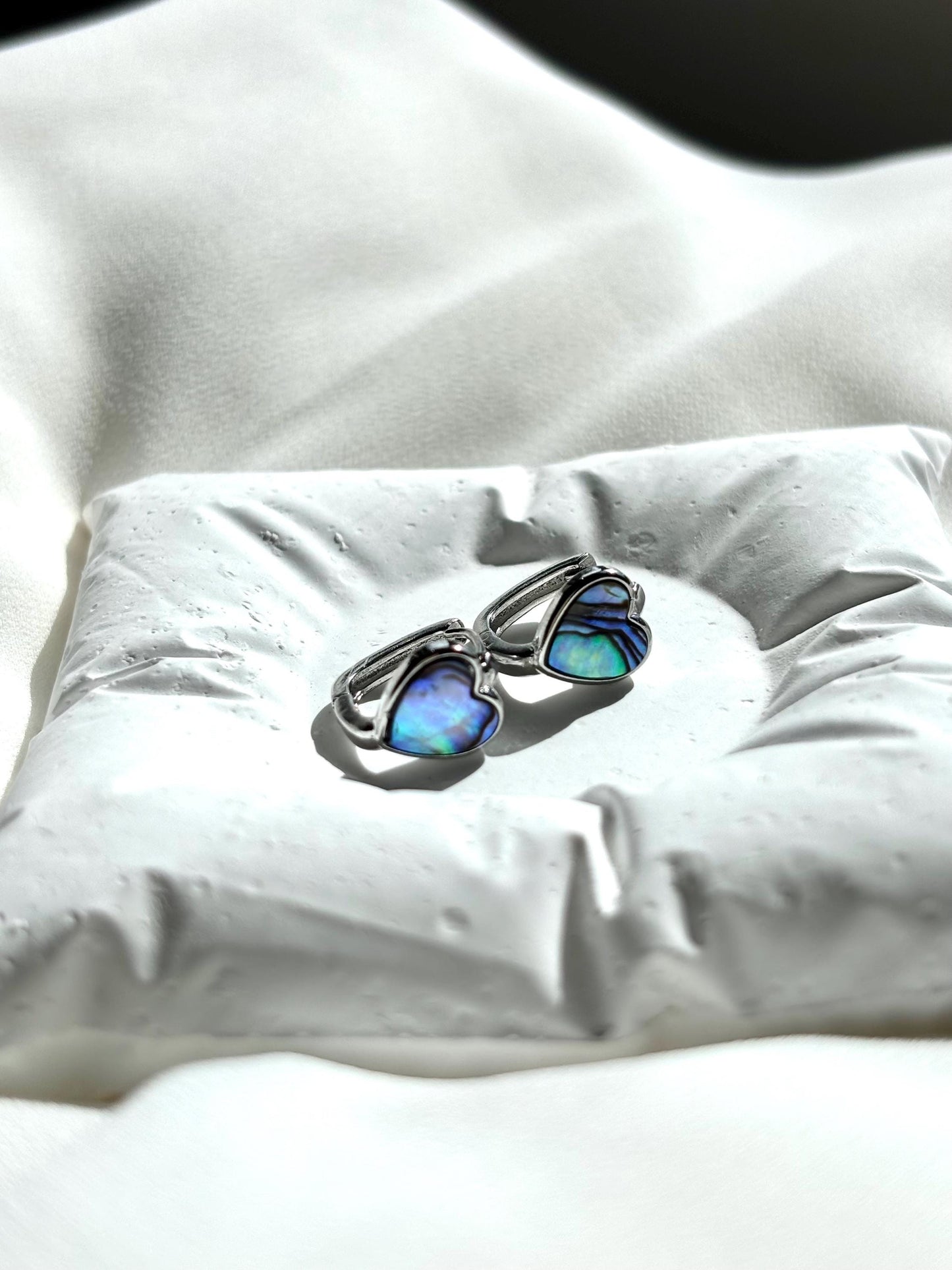 Heart-Shaped Mother of Pearl Huggie Earrings with Black and Blue Hues – Sterling Silver Wire