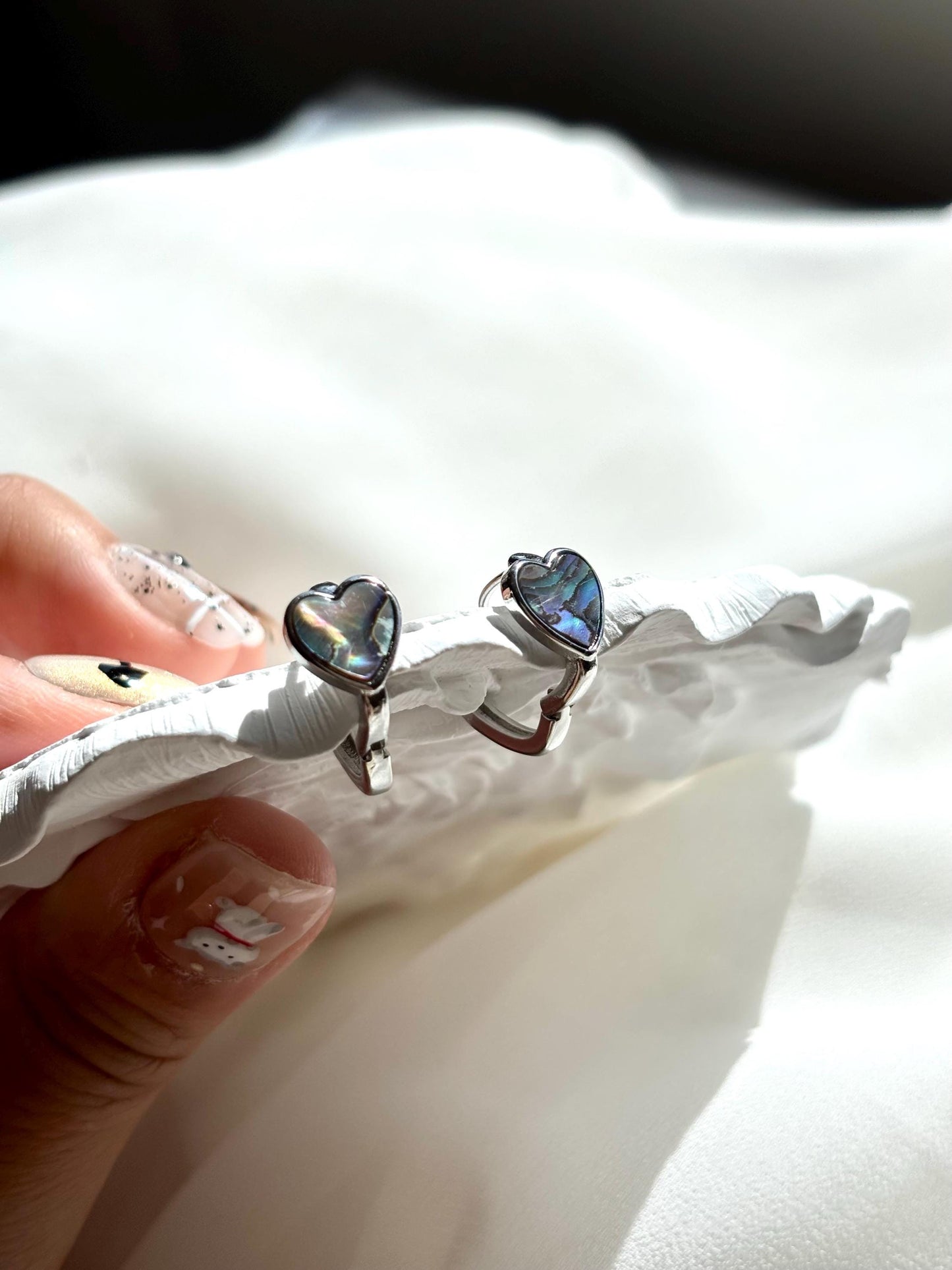 Heart-Shaped Mother of Pearl Huggie Earrings with Black and Blue Hues – Sterling Silver Wire