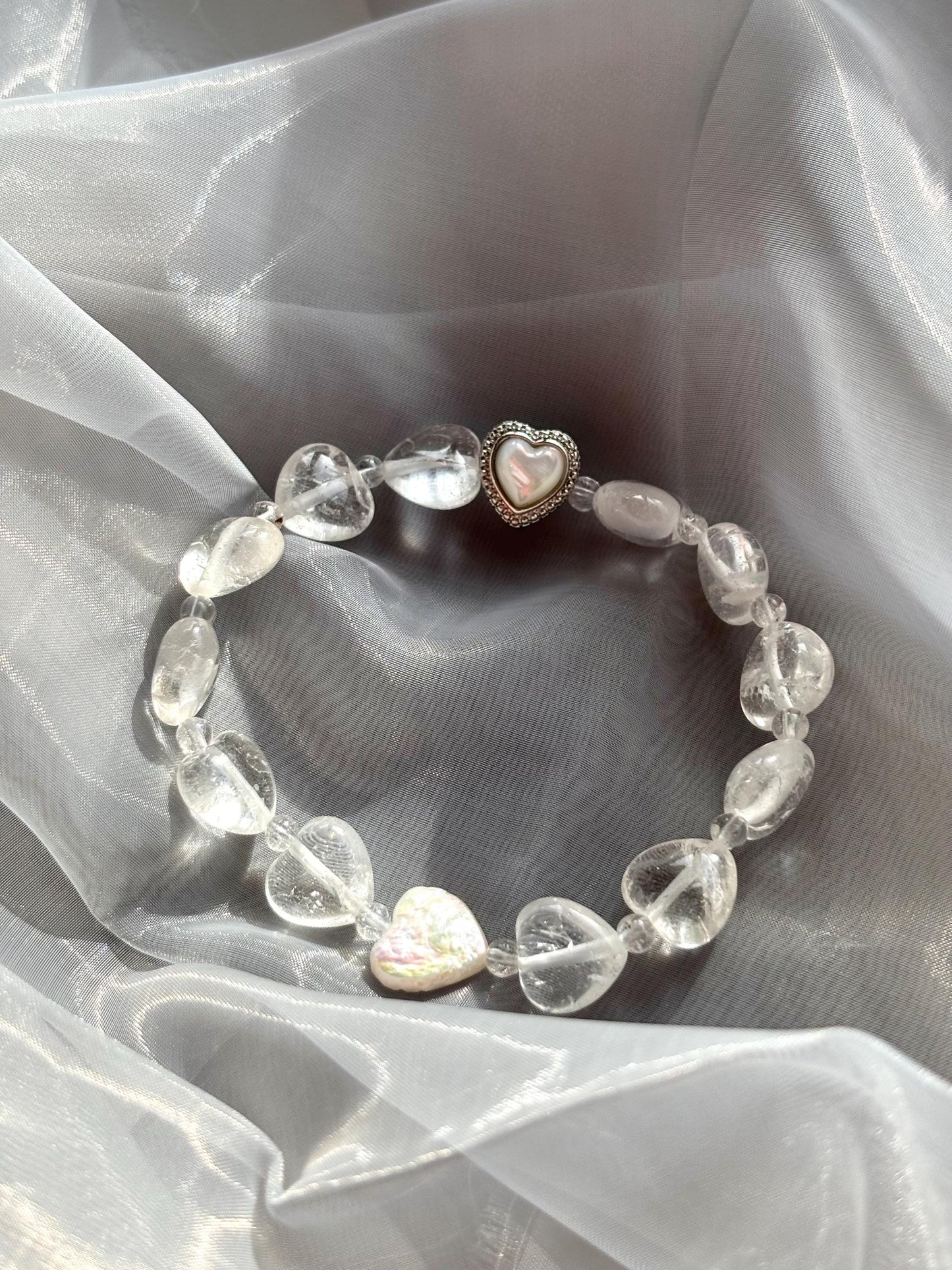 Icy Heart Clear Quartz Bracelet with Heart-Shaped Beads, Pearl, and Mother of Pearl Accents.
