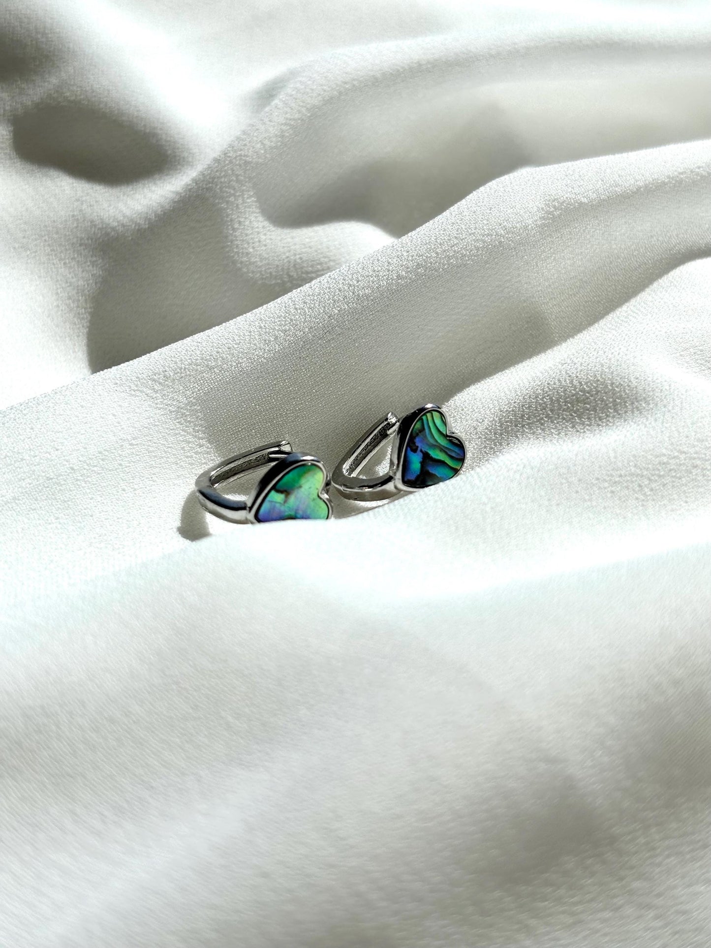 Heart-Shaped Mother of Pearl Huggie Earrings with Black and Blue Hues – Sterling Silver Wire