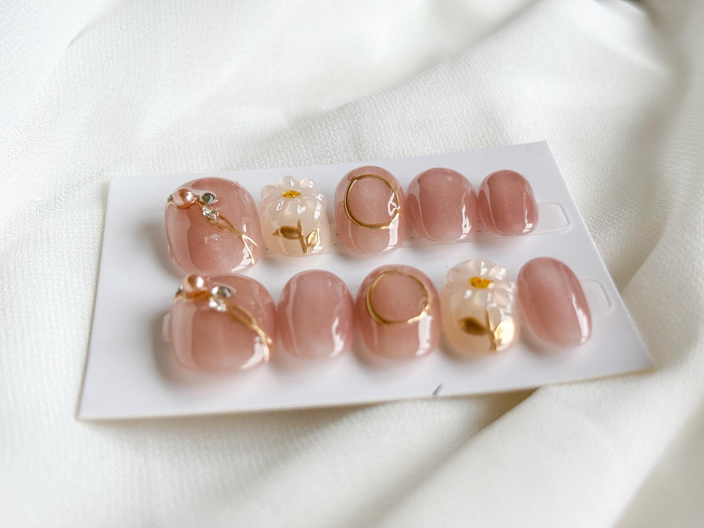 Blush Glow Press-On Nails – Pink Base with Gold Accents & White Floral Accent Nail